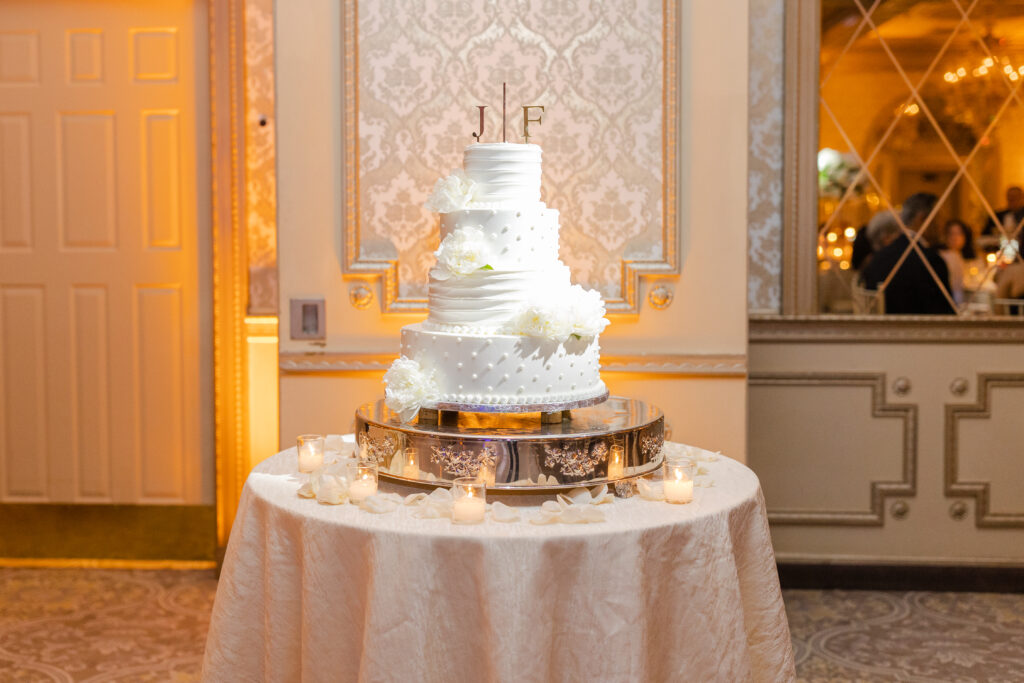 Cake cutting with bride and groom inside wedding reception