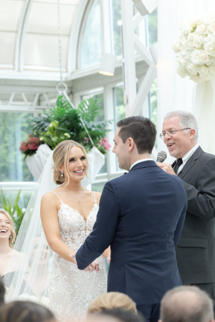 Bride and groom at wedding ceremony inside Madison Hotel Conservatory