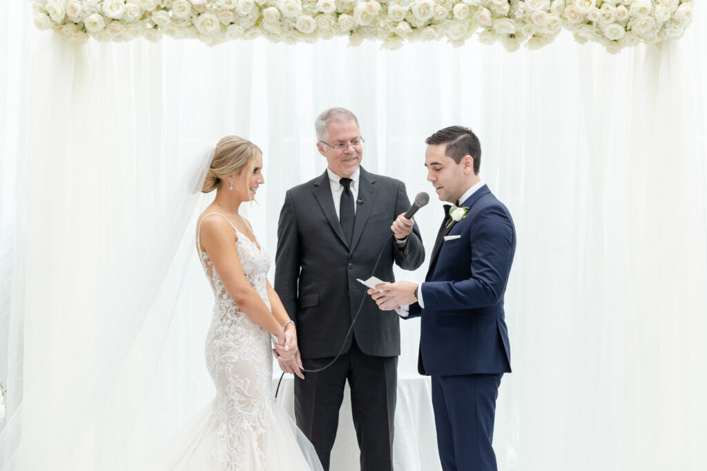 Groom reading vows at wedding ceremony inside NJ Wedding venue