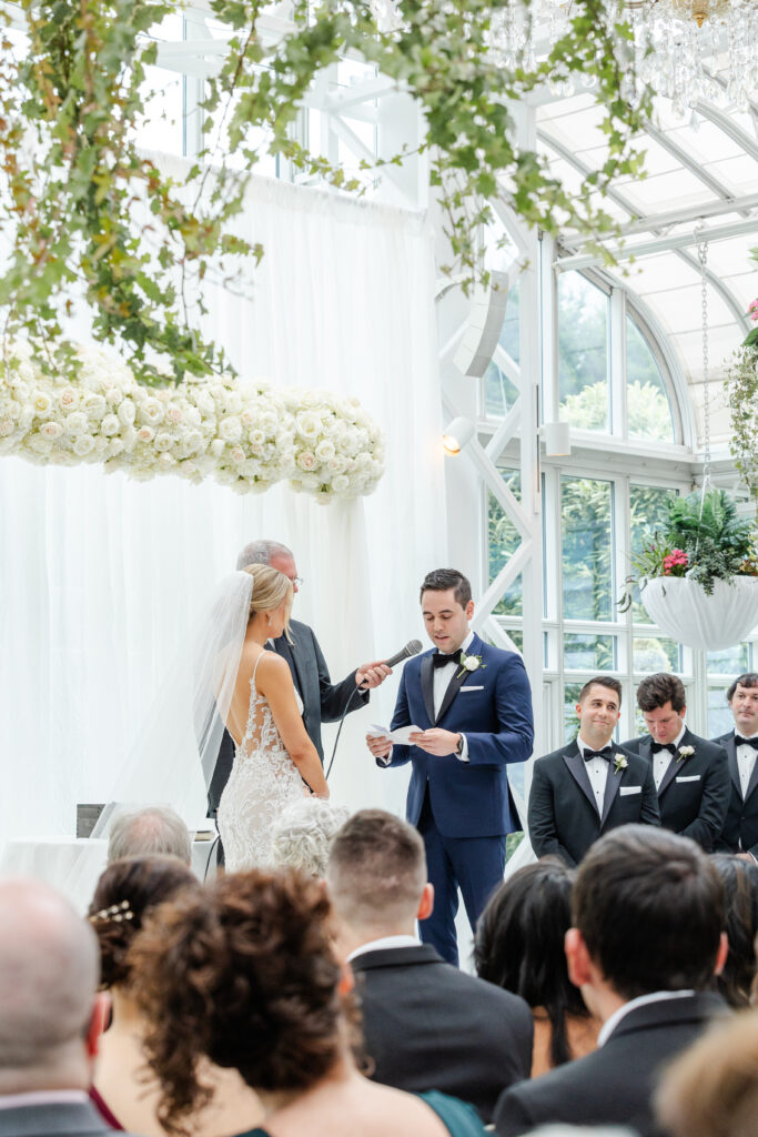 Groom reading vows at wedding ceremony inside NJ Wedding venue