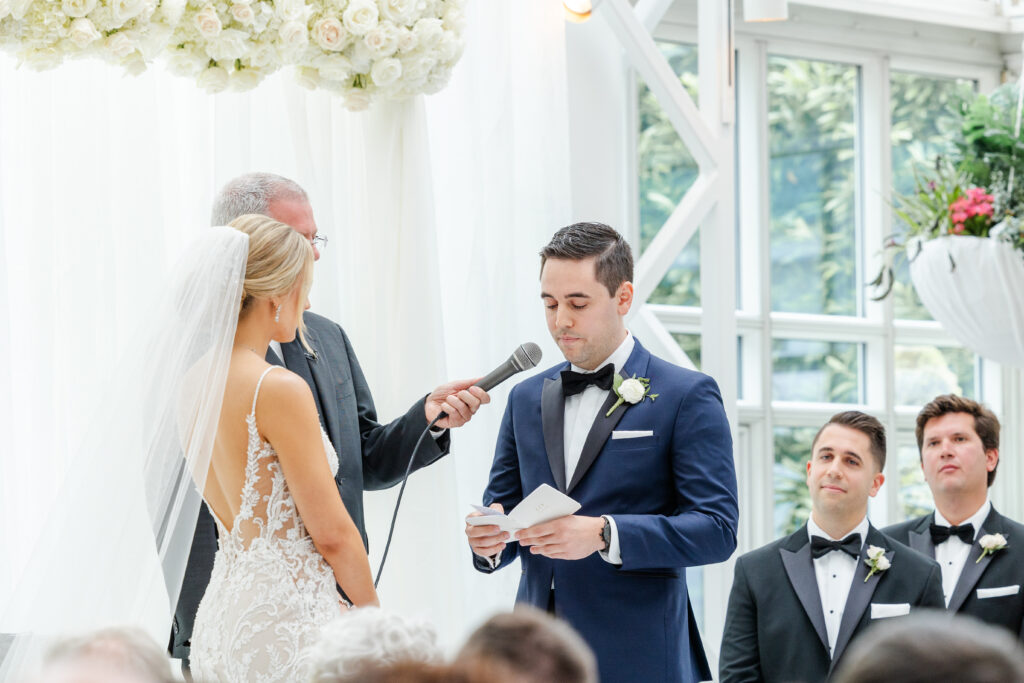 Groom reading vows at wedding ceremony inside NJ Wedding venue