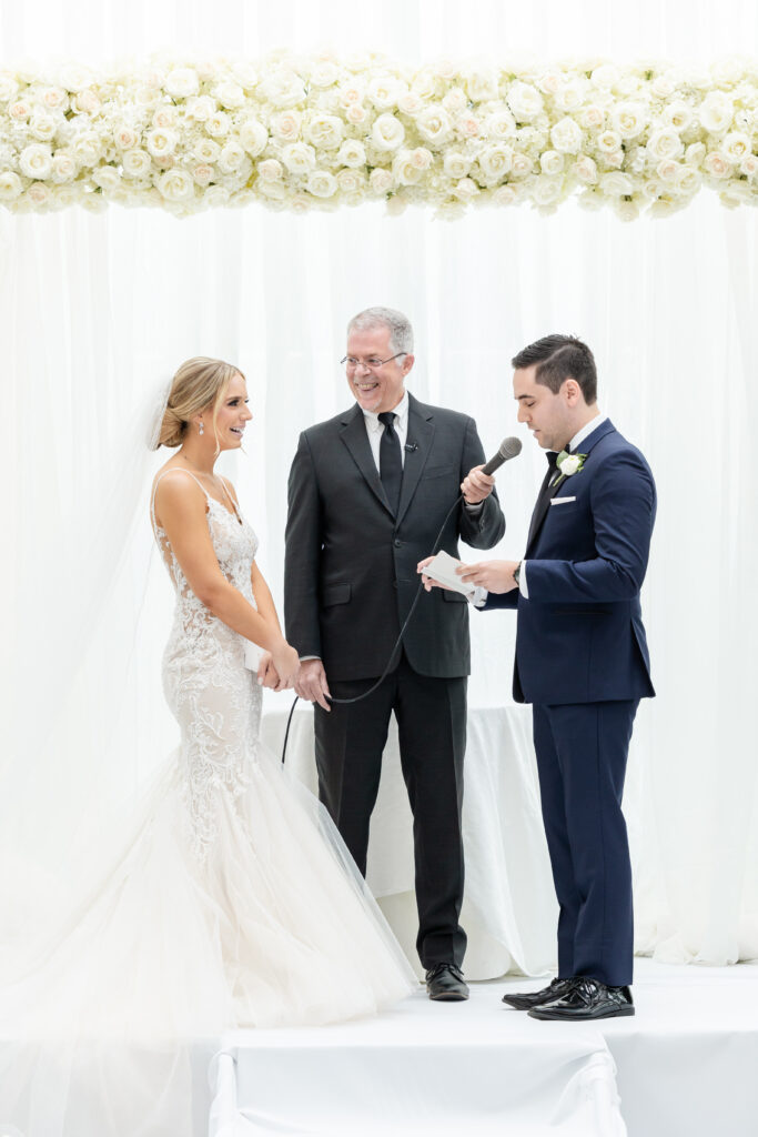 Groom reading vows at wedding ceremony inside NJ Wedding venue