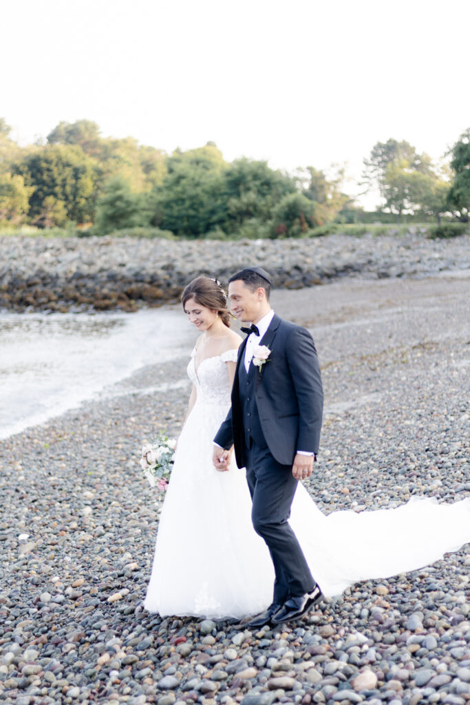 Bride and groom walking along the beach