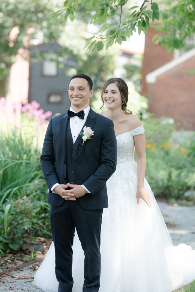 First look between bride and groom outside of Salem Waterfront Hotel