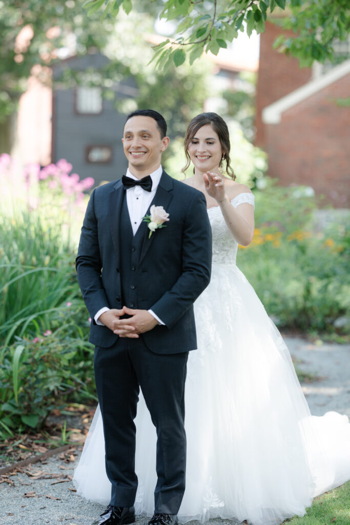 First look between bride and groom outside of Salem Waterfront Hotel