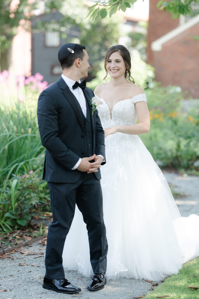 First look between bride and groom outside of Salem Waterfront Hotel