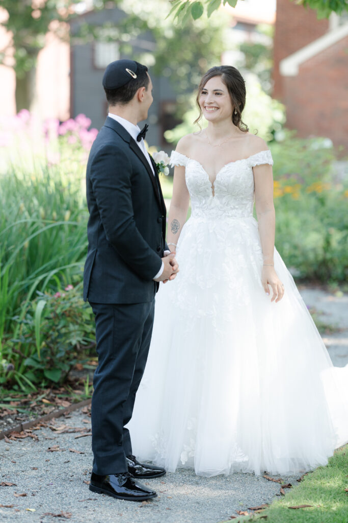 First look between bride and groom outside of Salem Waterfront Hotel