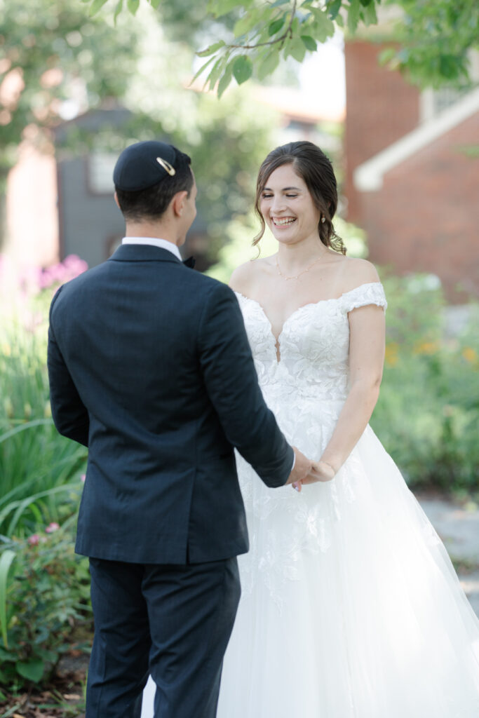 First look between bride and groom outside of Salem Waterfront Hotel