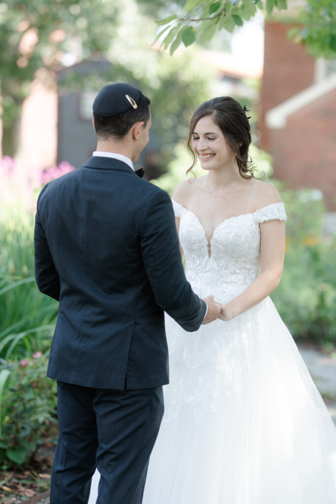 First look between bride and groom outside of Salem Waterfront Hotel