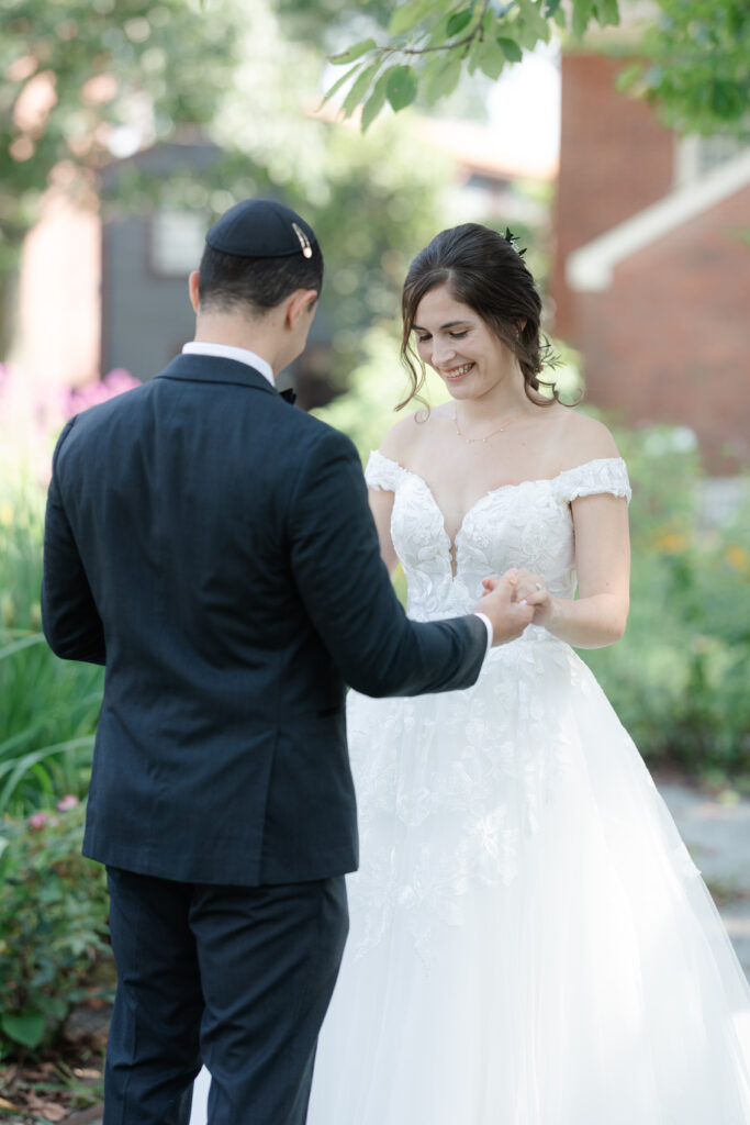 First look between bride and groom outside of Salem Waterfront Hotel