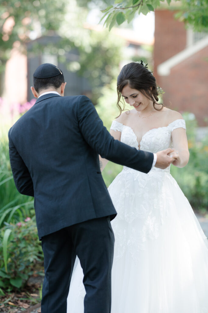 First look between bride and groom outside of Salem Waterfront Hotel