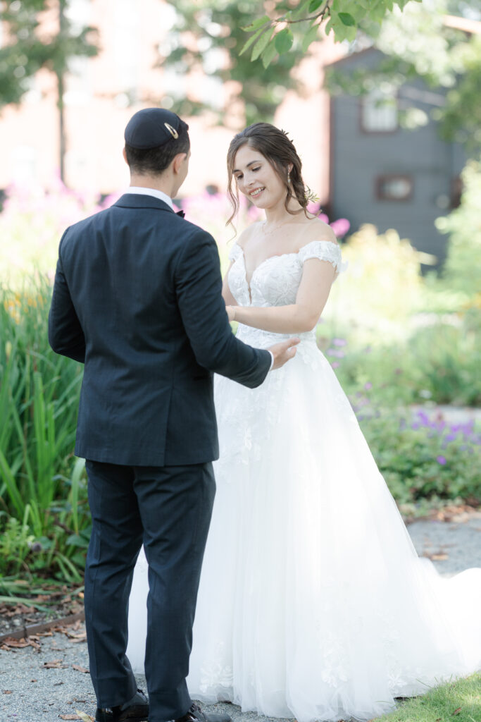 First look between bride and groom outside of Salem Waterfront Hotel