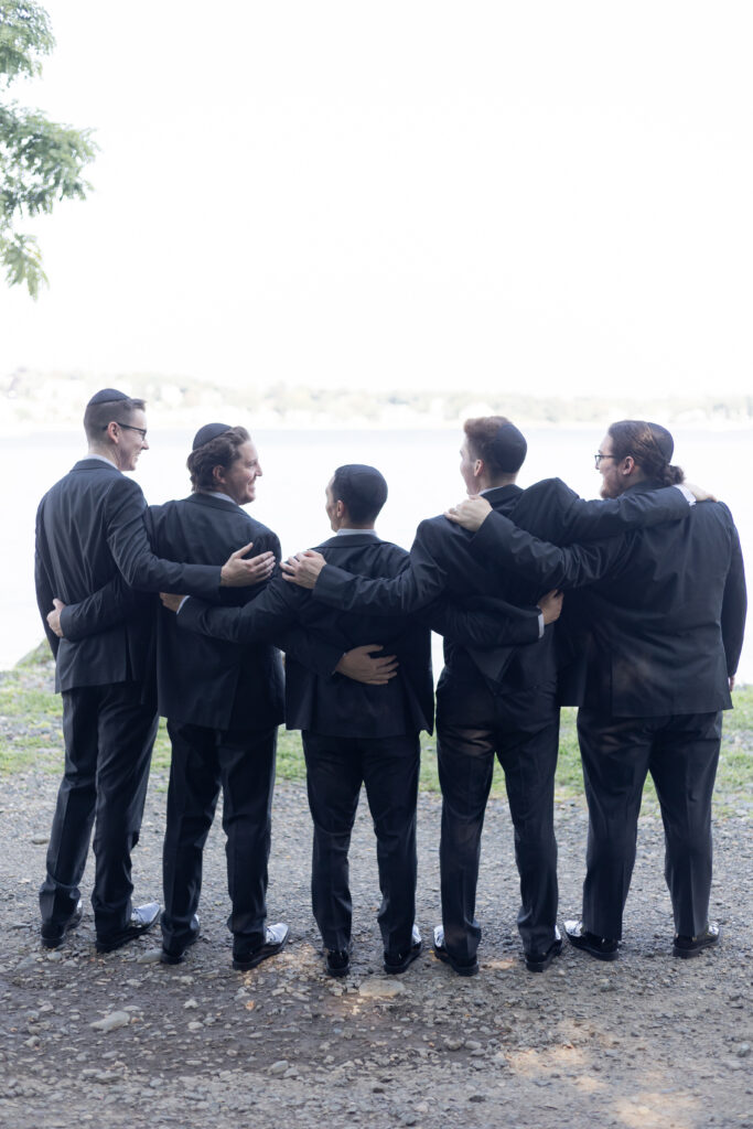 Groomsmen looking out of ocean view waterfront