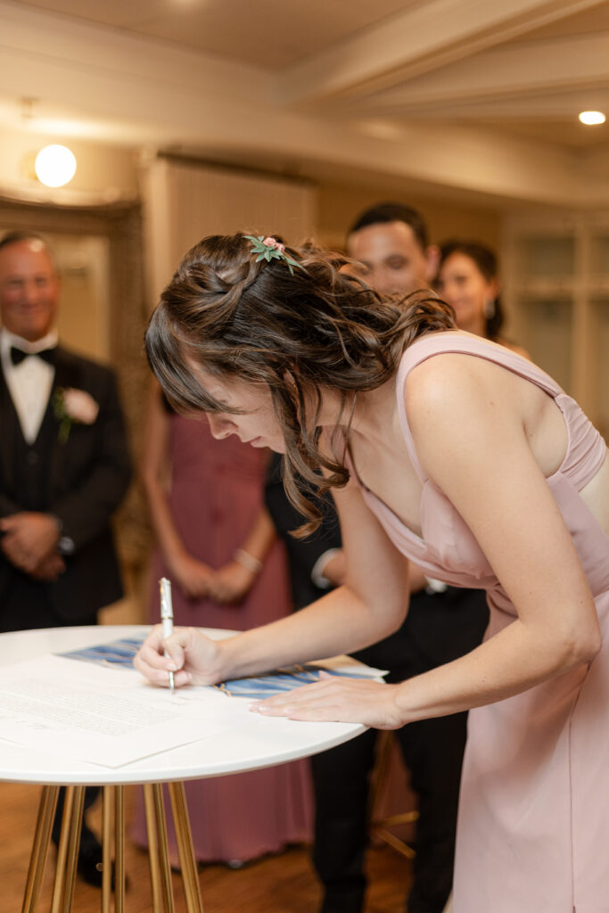 Private signing of ketubah inside wedding venue