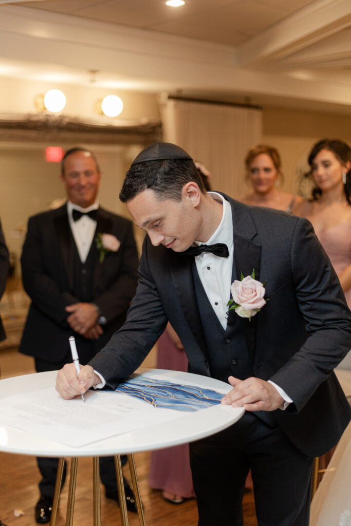 Private signing of ketubah inside wedding venue