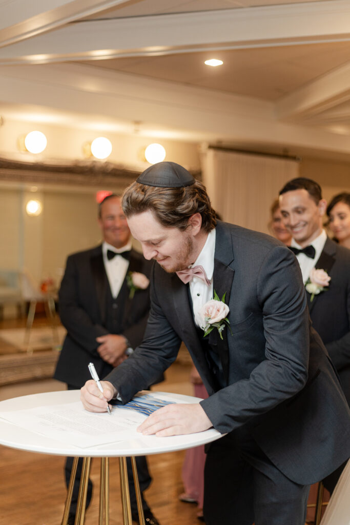 Private signing of ketubah inside wedding venue