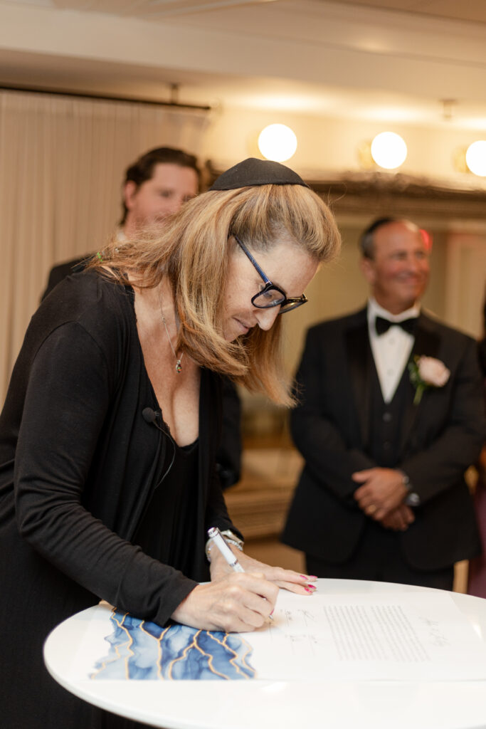 Private signing of ketubah inside wedding venue