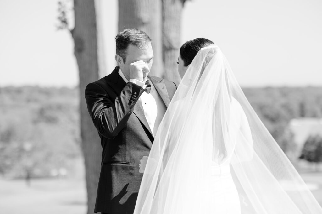 Black and white outdoor first look with bride and groom