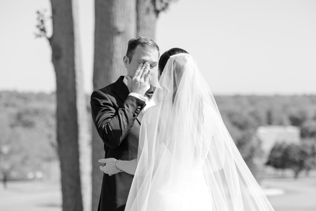 Black and white outdoor first look with bride and groom