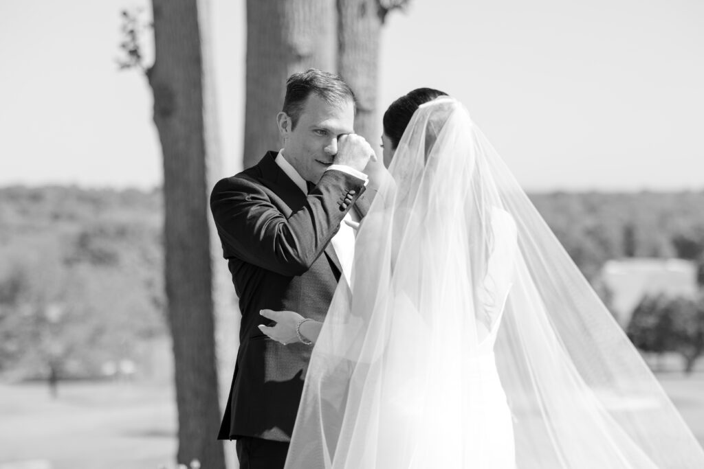 Black and white outdoor first look with bride and groom