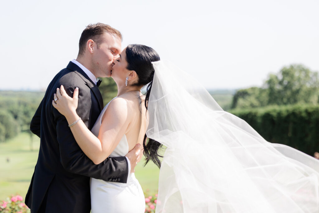 Bride and groom kissing portrait