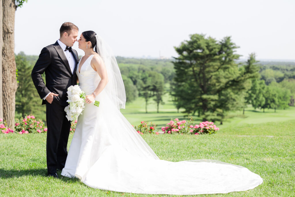 Bride and groom looking at each other outside wedding venue