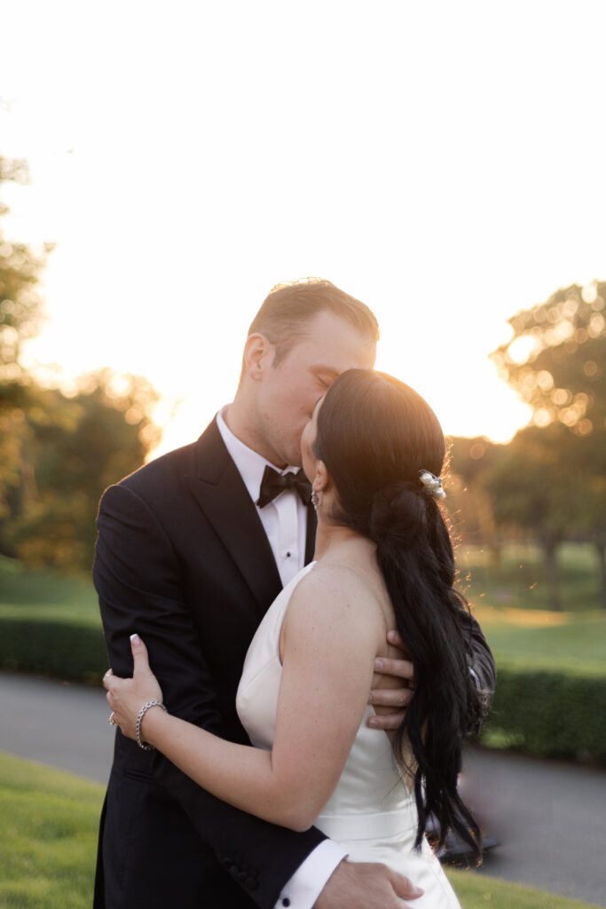 Bride and groom sunset photos outside country club venue