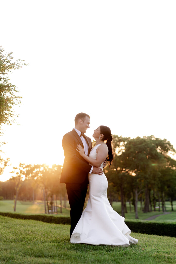 Bride and groom sunset photos outside country club venue