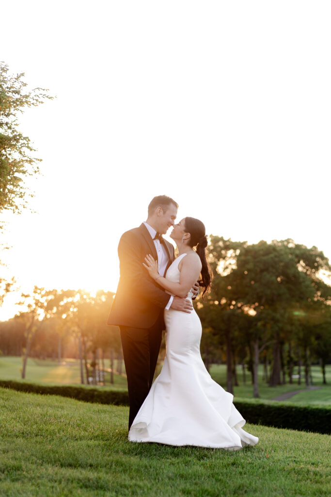 Bride and groom sunset photos outside country club venue