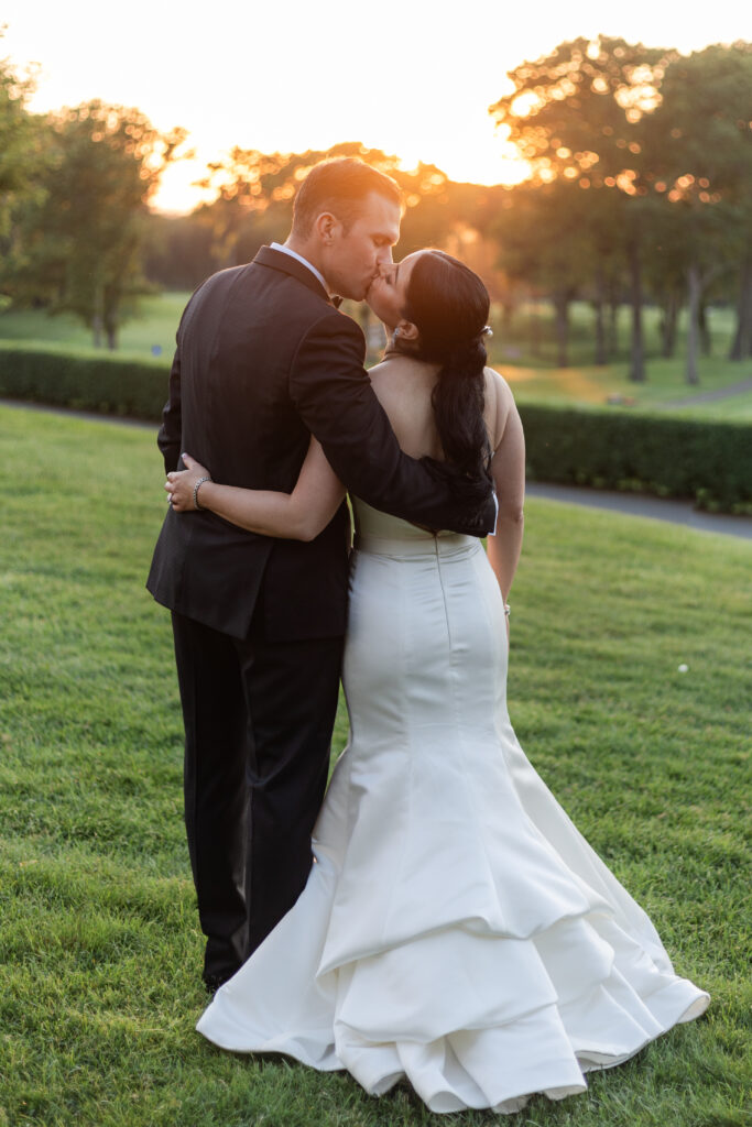 Bride and groom sunset photos outside golf club wedding venue