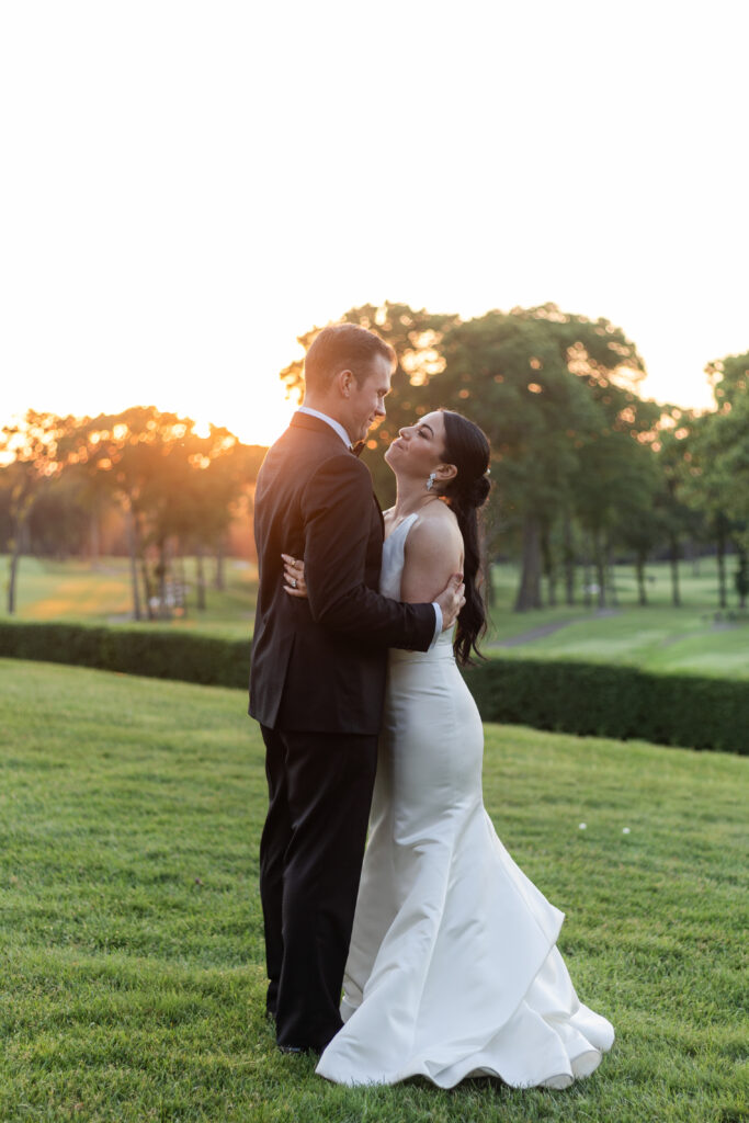 Bride and groom sunset photos outside golf club wedding venue