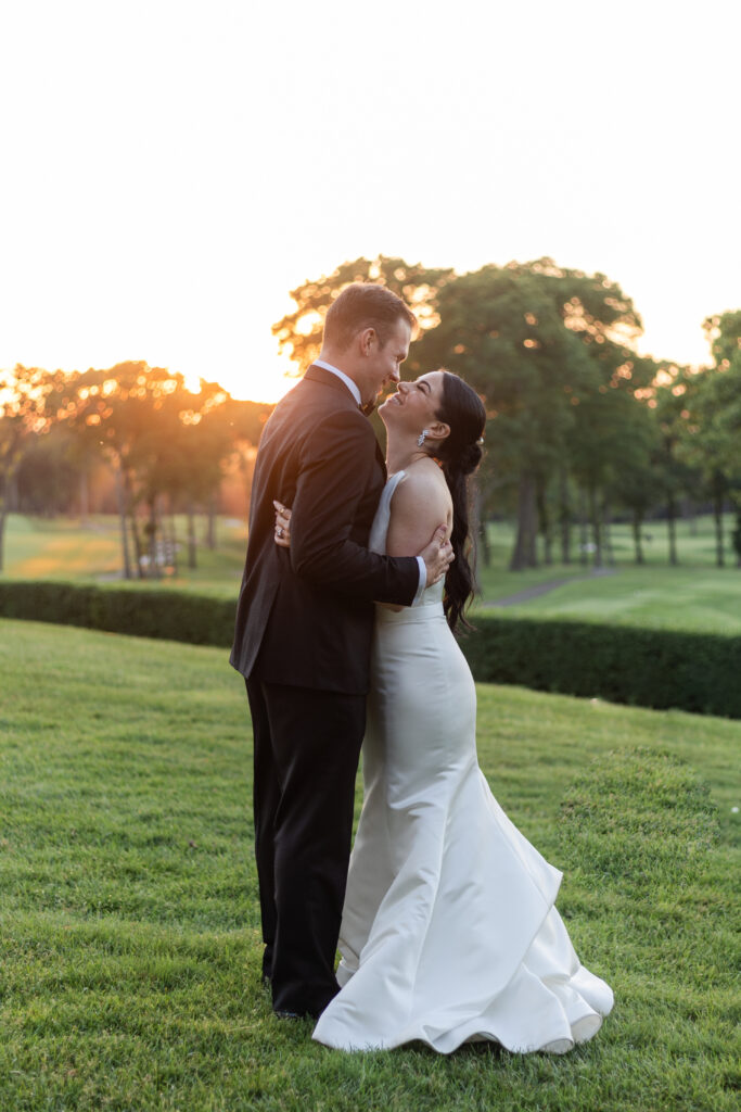 Bride and groom sunset photos outside golf club wedding venue