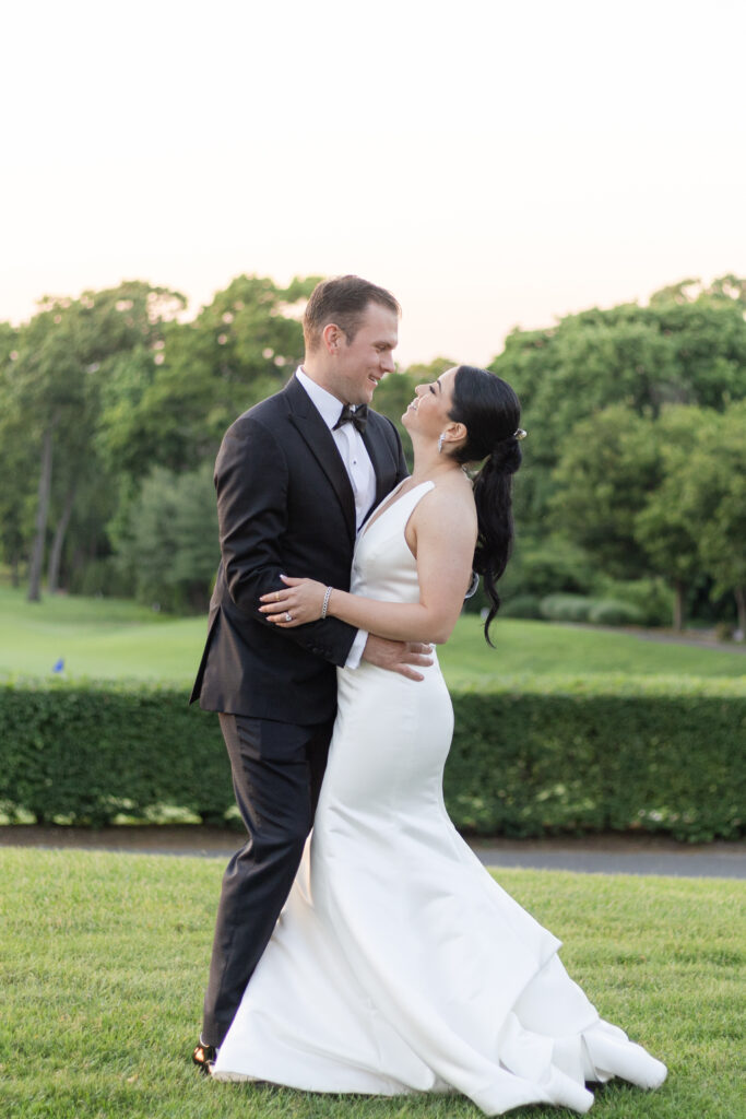 Bride and groom sunset photos outside golf club wedding venue