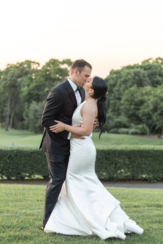 Bride and groom sunset photos outside golf club wedding venue