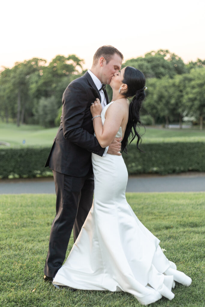 Bride and groom sunset photos outside golf club wedding venue