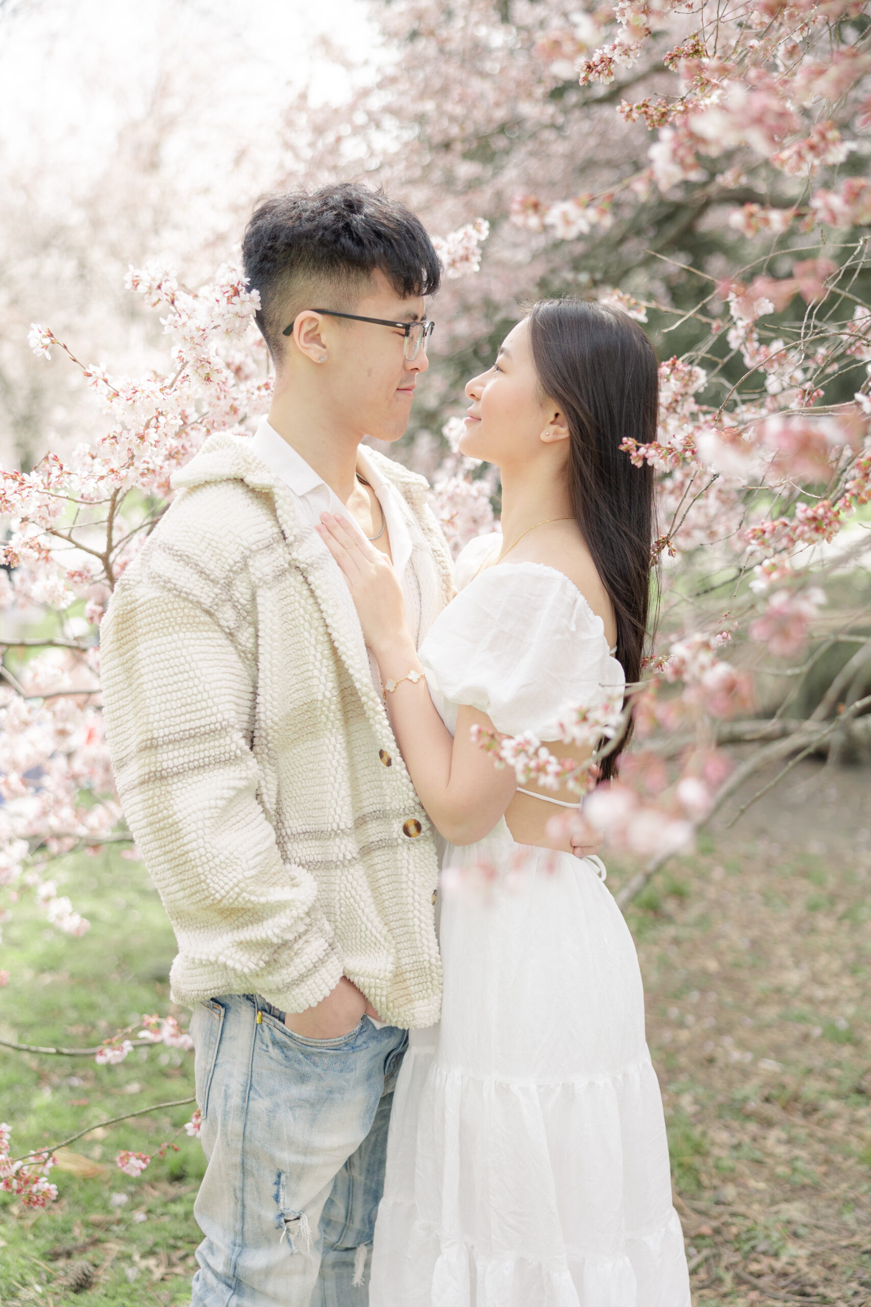 Engagement in NYC Central Park cherry blossoms romantic couple