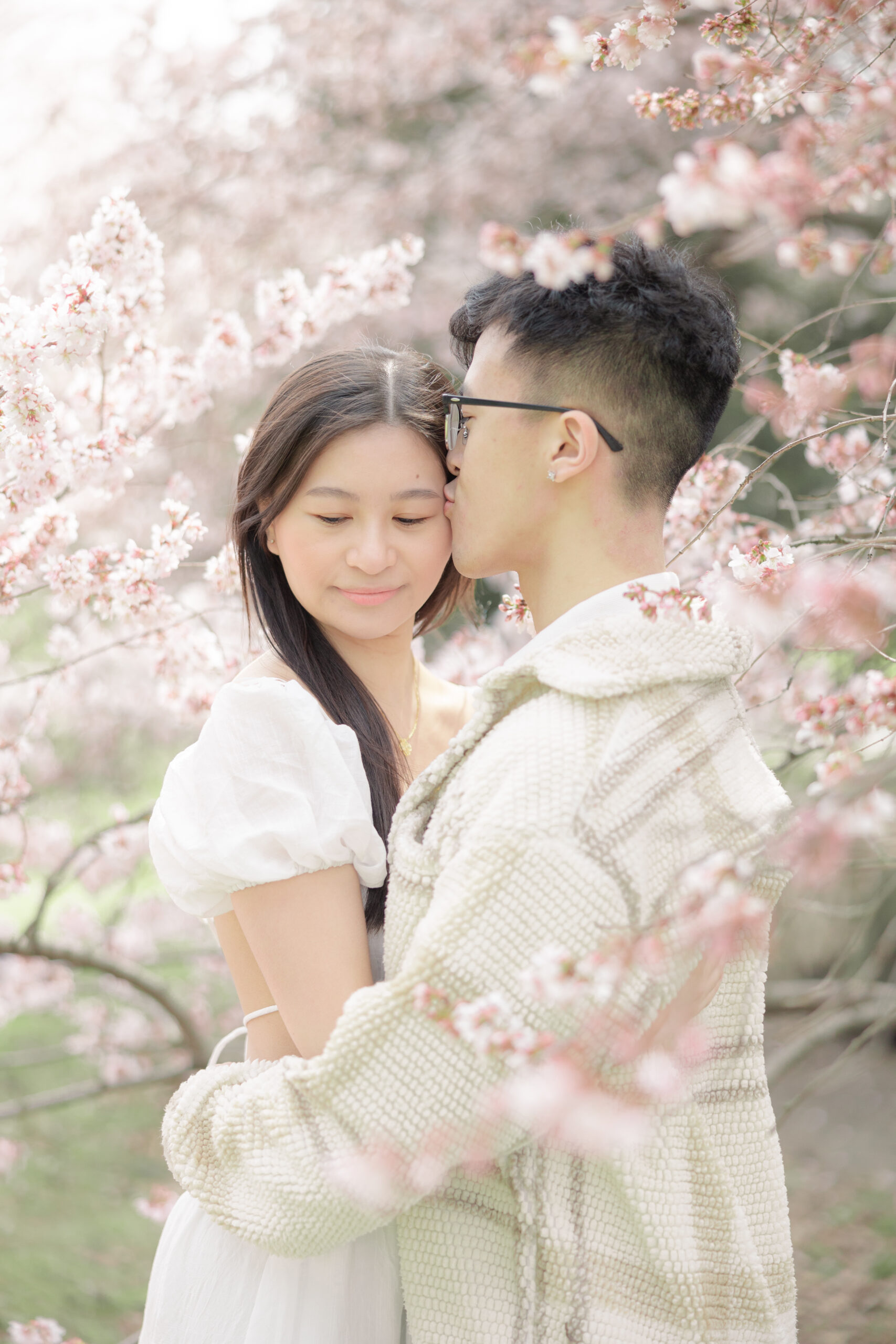 Engagement in NYC Central Park cherry blossoms romantic couple
