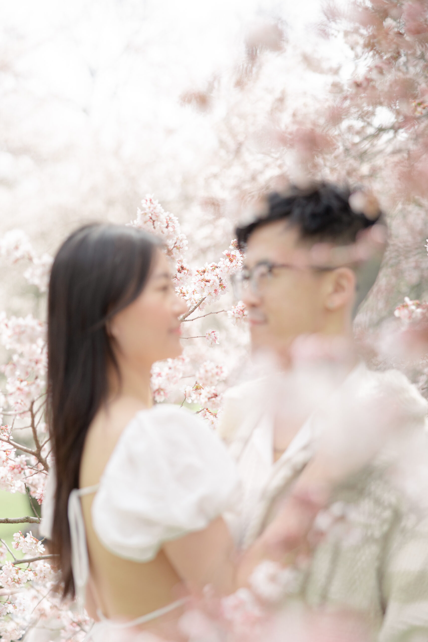 NYC engagement photographer capturing couple under pink blooms