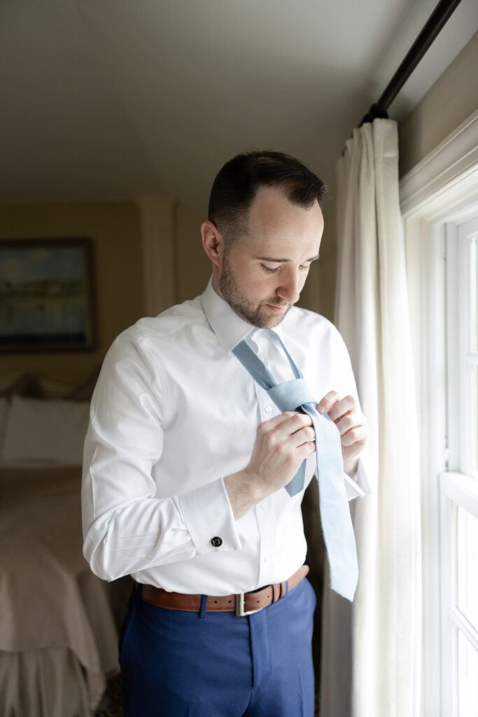 Groom getting ready at Basking Ridge Hotel's suite