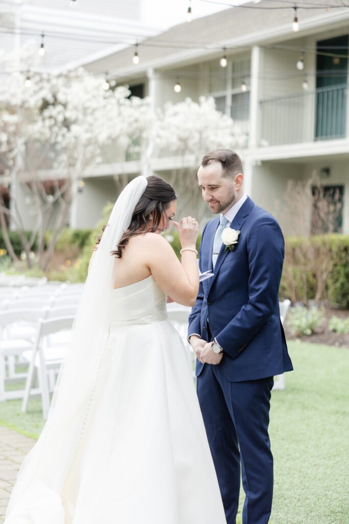 Bride reading private vows to groom outside luxury hotel wedding venue