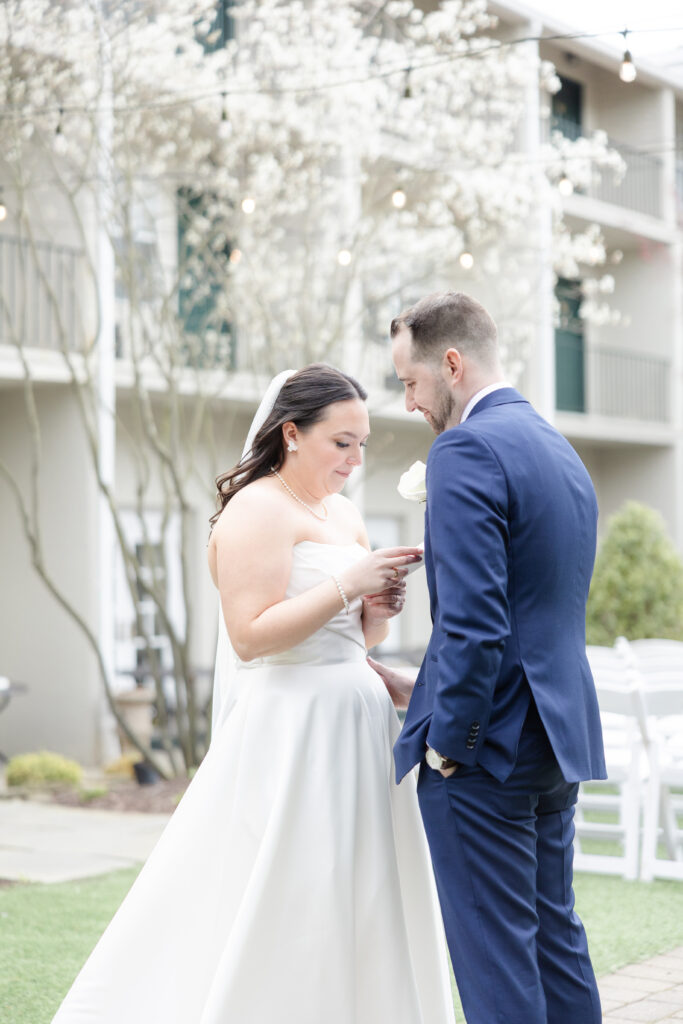 Bride reading private vows to groom outside luxury hotel wedding venue