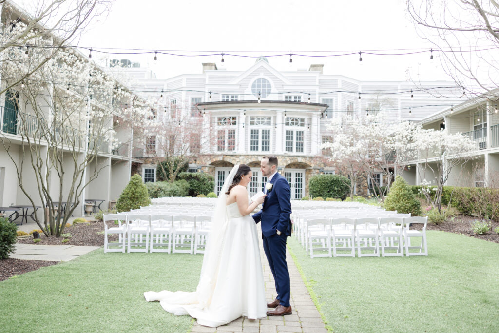 Bride reading private vows to groom outside luxury hotel wedding venue