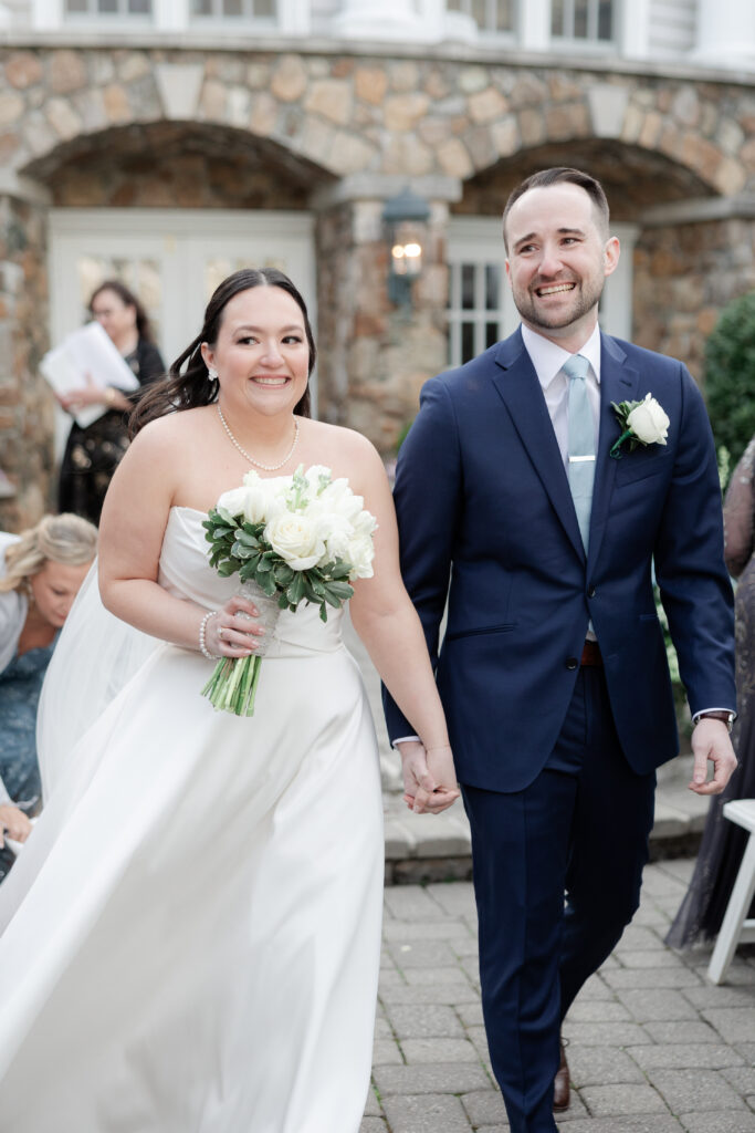 Bride and groom walking down the aisle at outdoor wedding ceremony