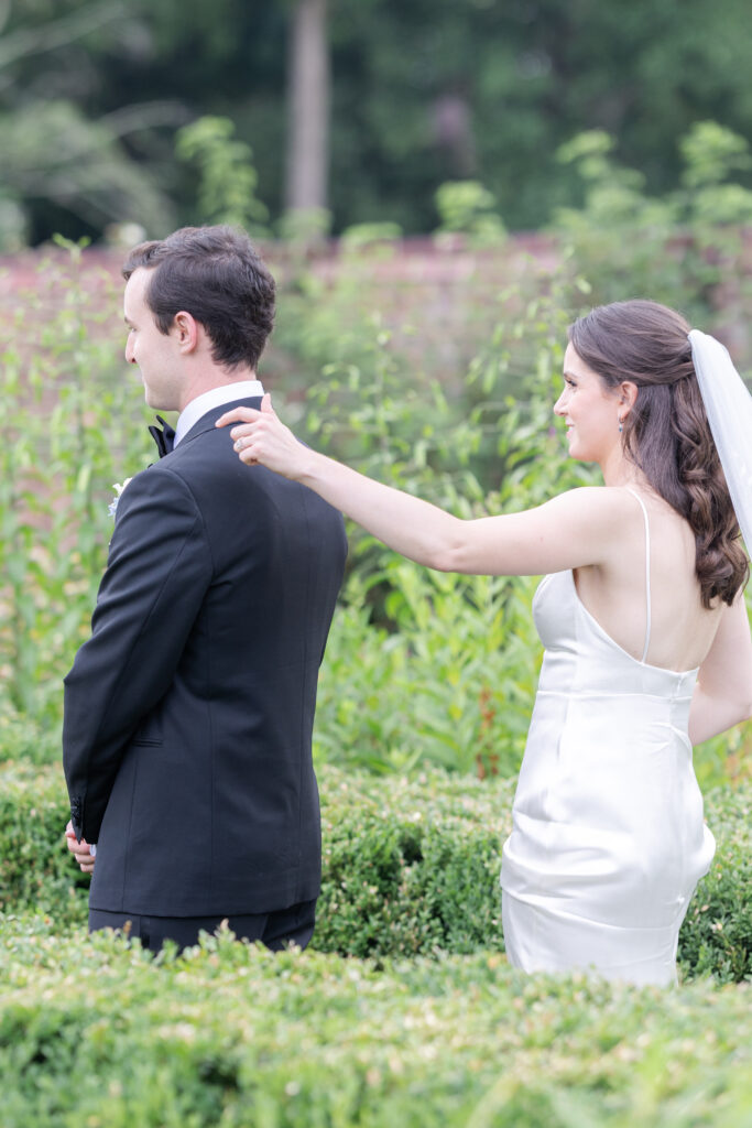 Outdoor first look at garden wedding venue between bride and groom