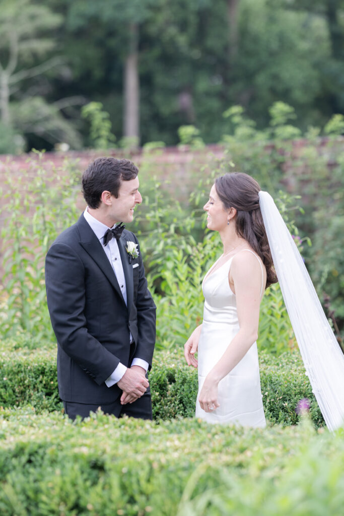 Outdoor first look at garden wedding venue between bride and groom