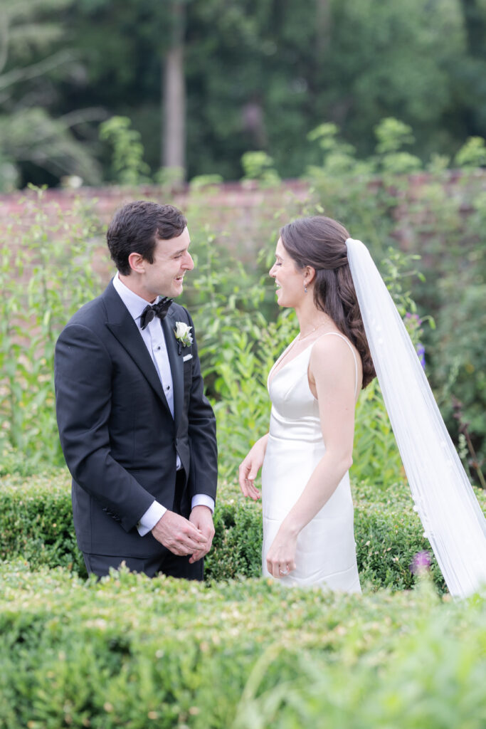 Outdoor first look at garden wedding venue between bride and groom