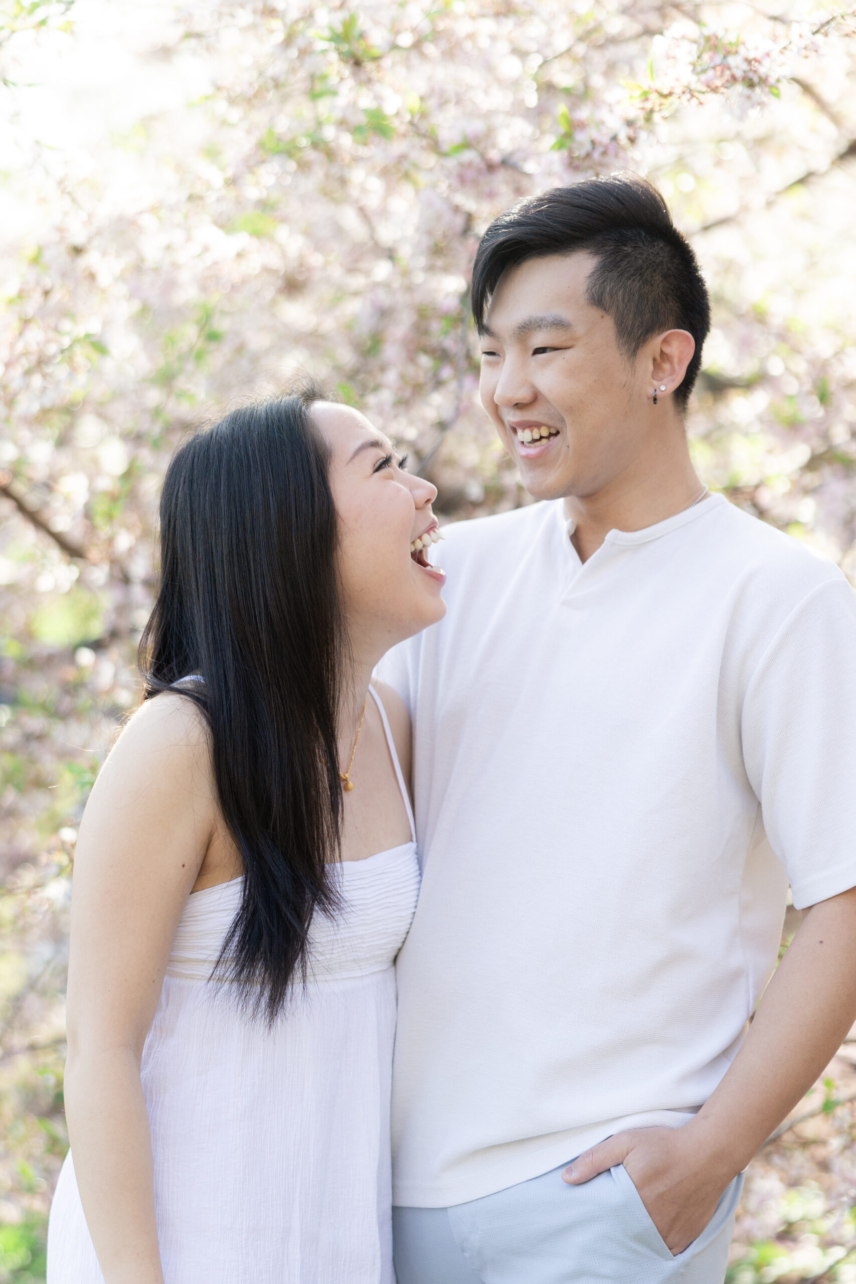 Couple with light pink cherry blossoms backdrop