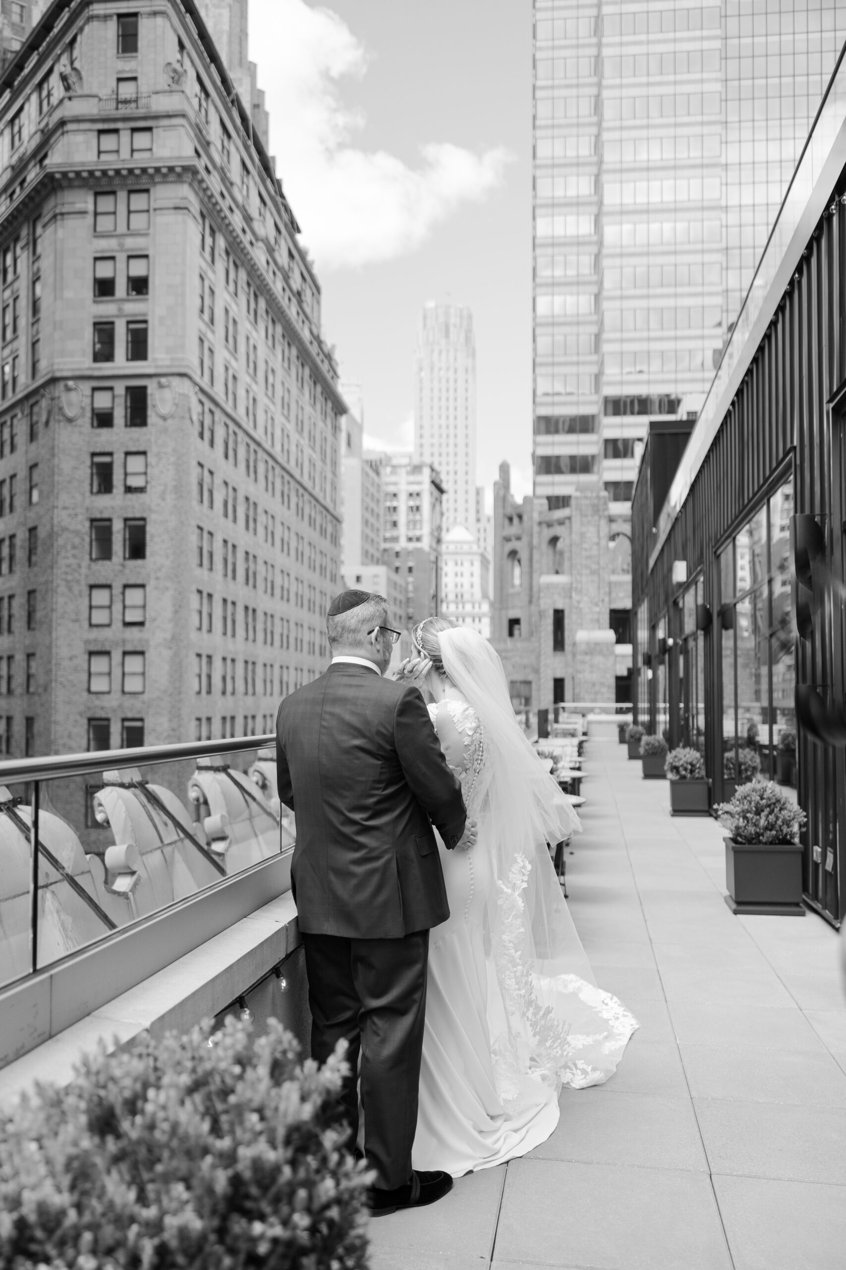 Bride and groom on the balcony of Wall Street Hotel Wedding Venue