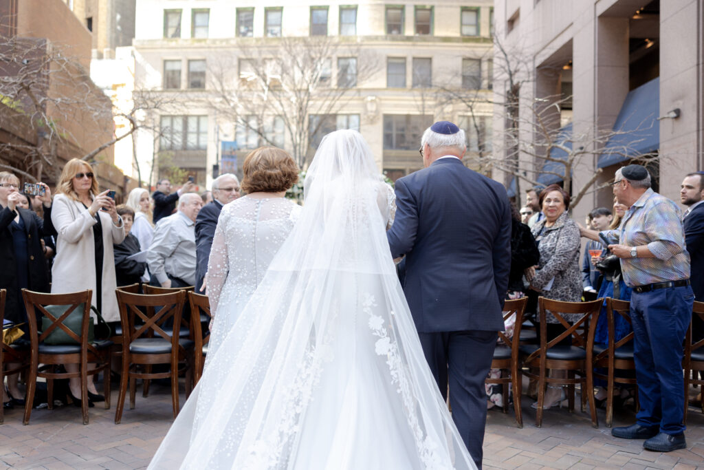 Bride and parents walking down the aisle at Wall Street Wedding Venue