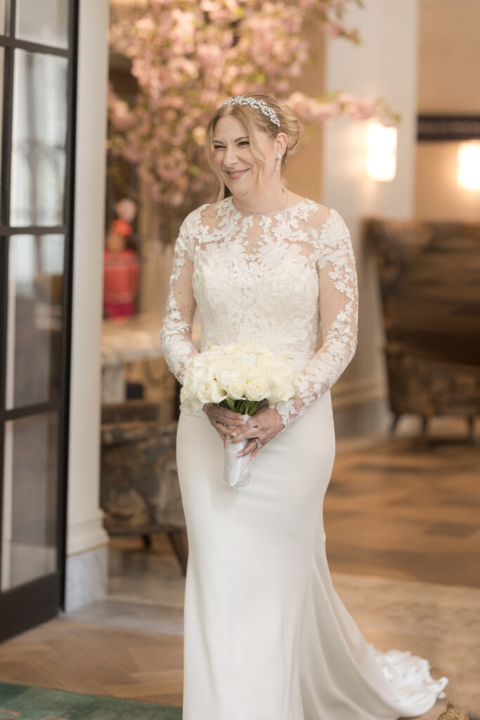 Bride walking inside downtown fidi hotel toward groom for first look